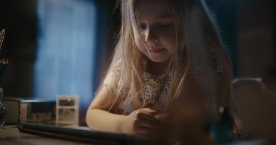 Girl using a tablet on a table