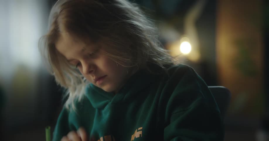 A female child writing with a pencil indoor