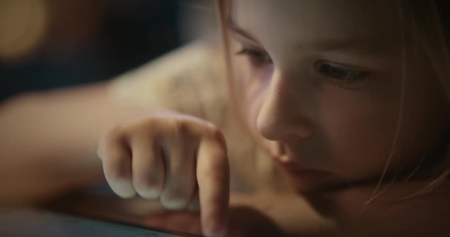 A young girl operating a device