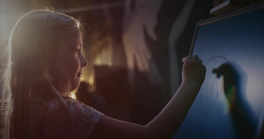 A girl drawing on a chalkboard
