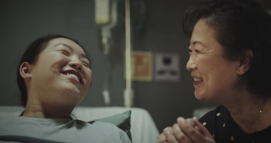 Two women talking in a hospital bed