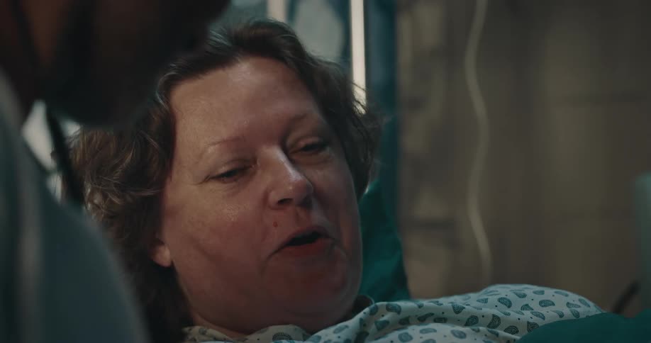 Doctor attending to a patient lying in a hospital bed in a hospital room