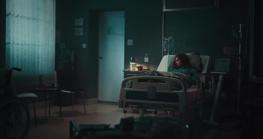 A woman is sleeping in a hospital bed