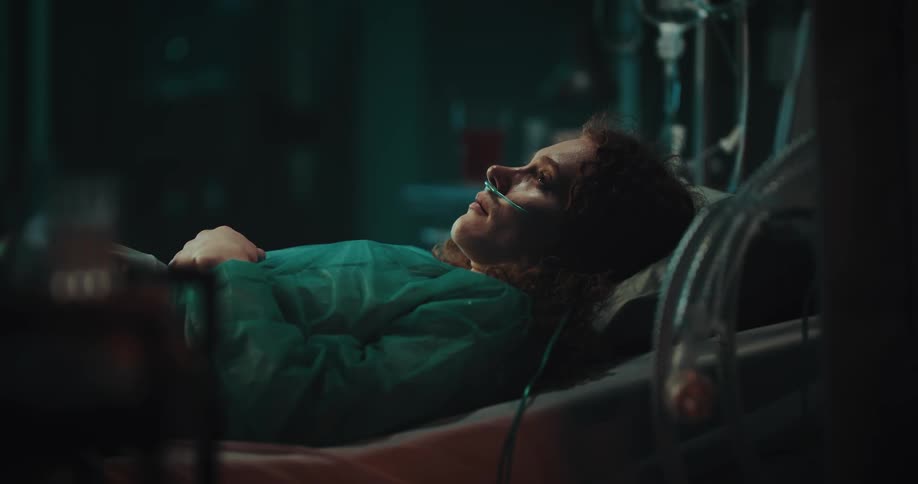 Woman lying in the hospital bed with a nasal cannula