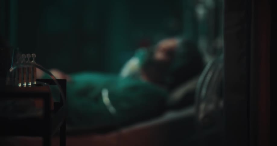 A out of focus person resting in a bed in a hospital setting
