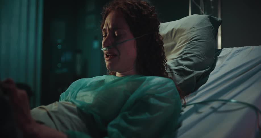 Woman lying alone in the hospital bed crying intensely in despair