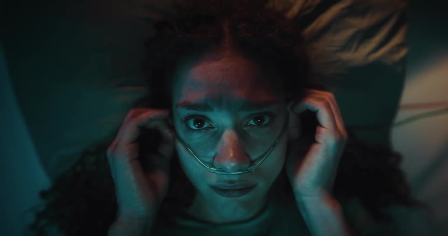 Portrait of a woman lying in bed with a hospital nasal cannula
