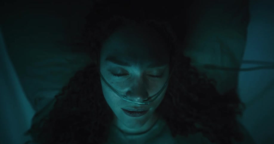 A woman laying on a bed with a hose in her nose shaking around