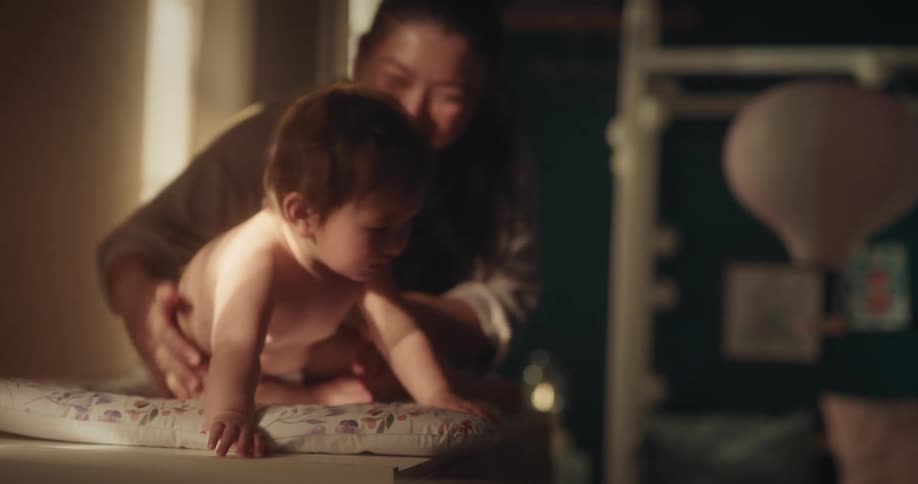A mother is showing her baby some toys