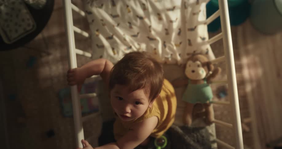 Baby girl in the crib looking upward