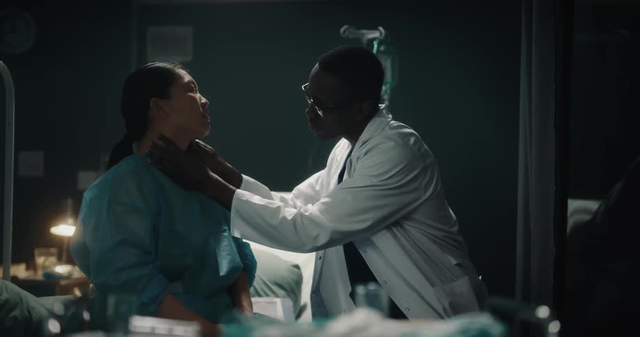 Doctor consulting a patient and examining her neck