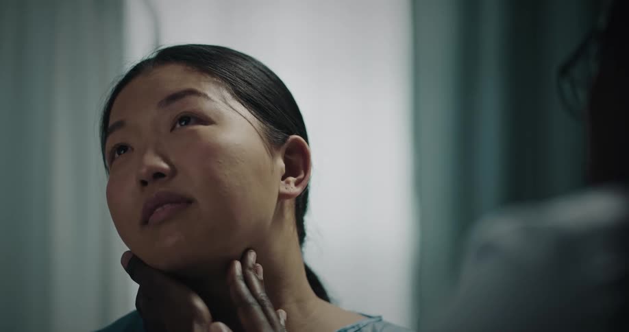 Doctor examining a patients neck