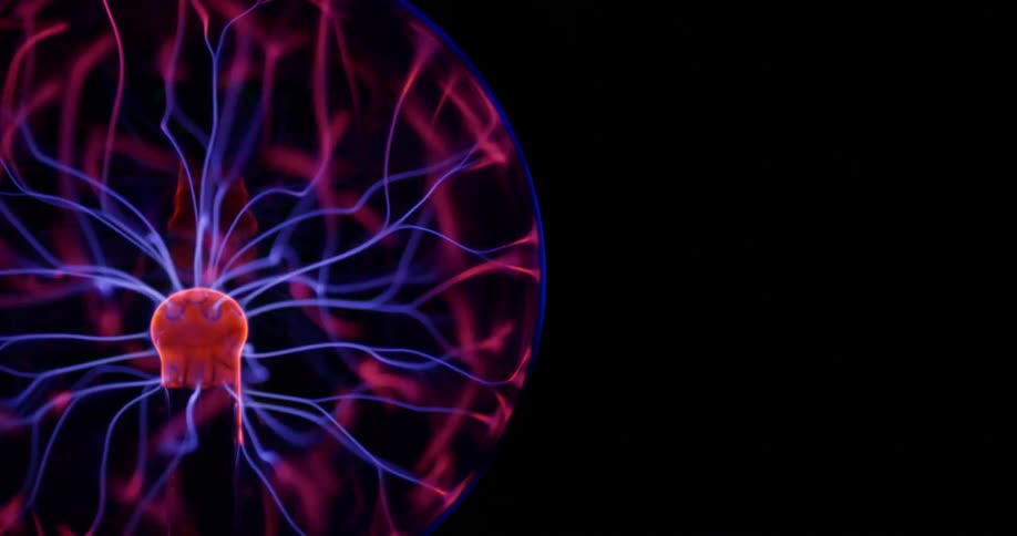 Glowing purple wisps move inside an orb of electric energy from a phosphorescent pink object