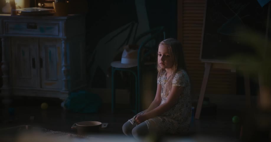 Girl sitting in a chair indoors and talking to someone