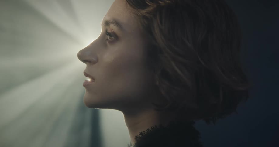 Portrait of a happy woman with reflections of lights on her