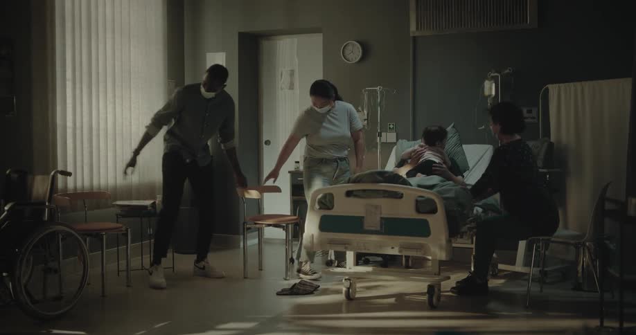 Family visiting a patient lying in the hospital bed
