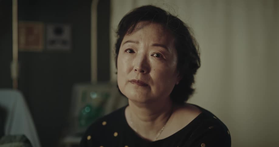 Asian woman slowly turns head to face forward