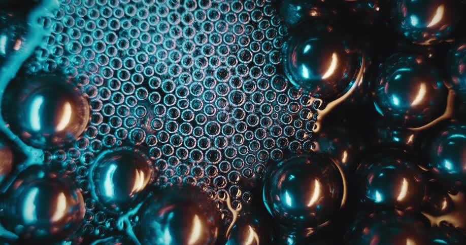 Bubbles of water next to shiny and abstract metallic spheres