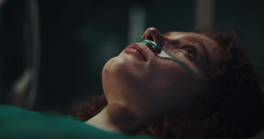 A girl with a nasal catheter waking up in a hospital