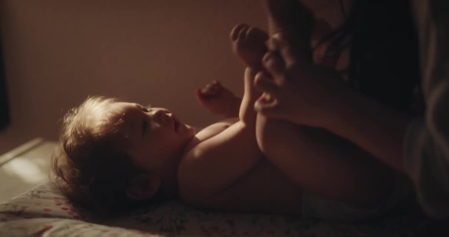 A mother is playing with her baby