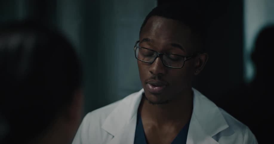 Doctor takes notes while talking to a patient
