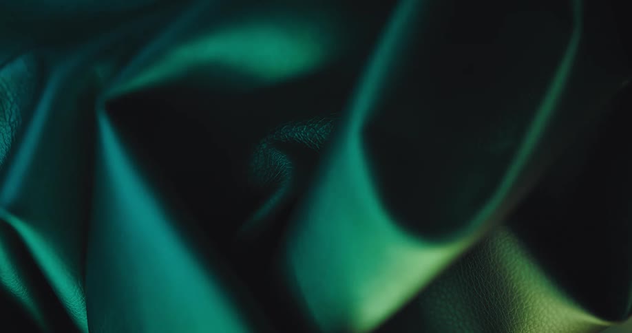 Close up of green cloth under moving lights and shadows