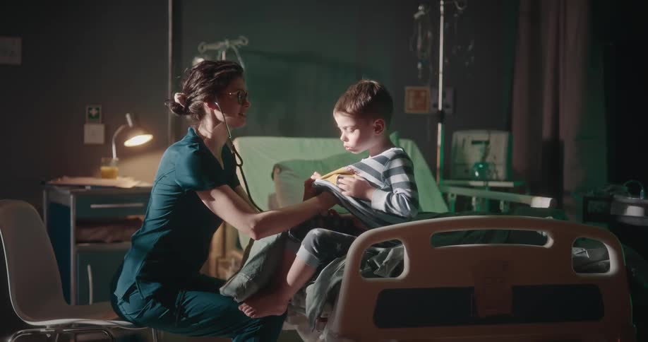 A nurse examining a boy in a hospital