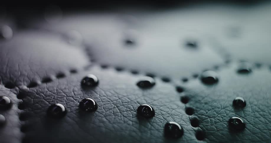 Water beads on stitched leather surface