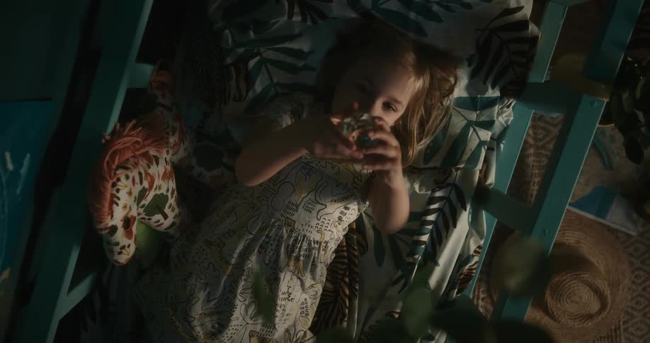 Gil resting inside a crib plays with a crystal ball
