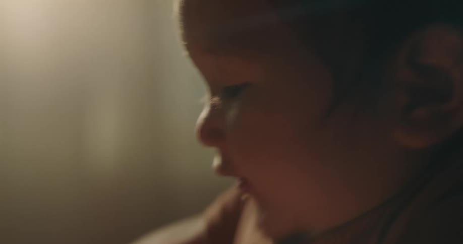 Portrait of a baby sitting on a table clapping her hands