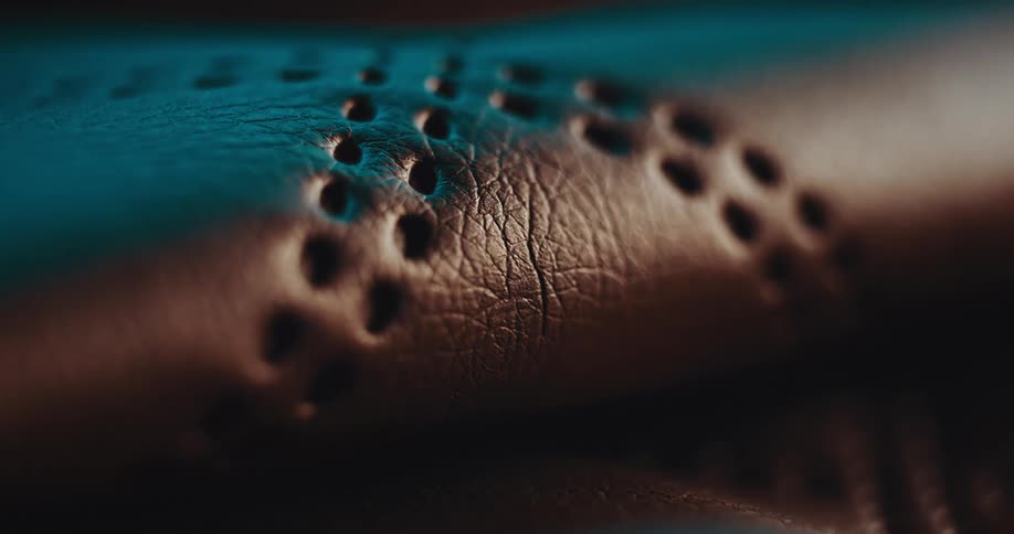Abstract light passing through a piece of perforated and abstract patterned leather