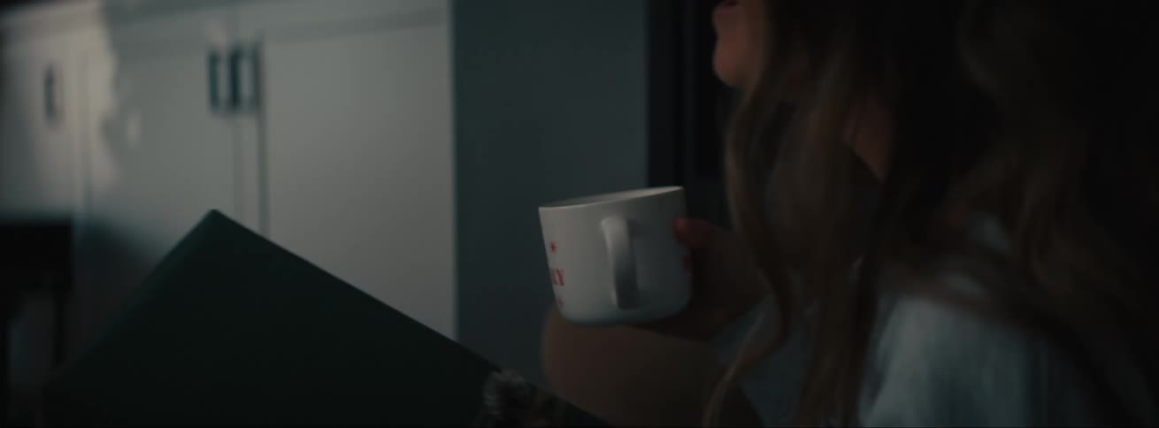 Portrait of a woman holding a cup and receiving a gift box