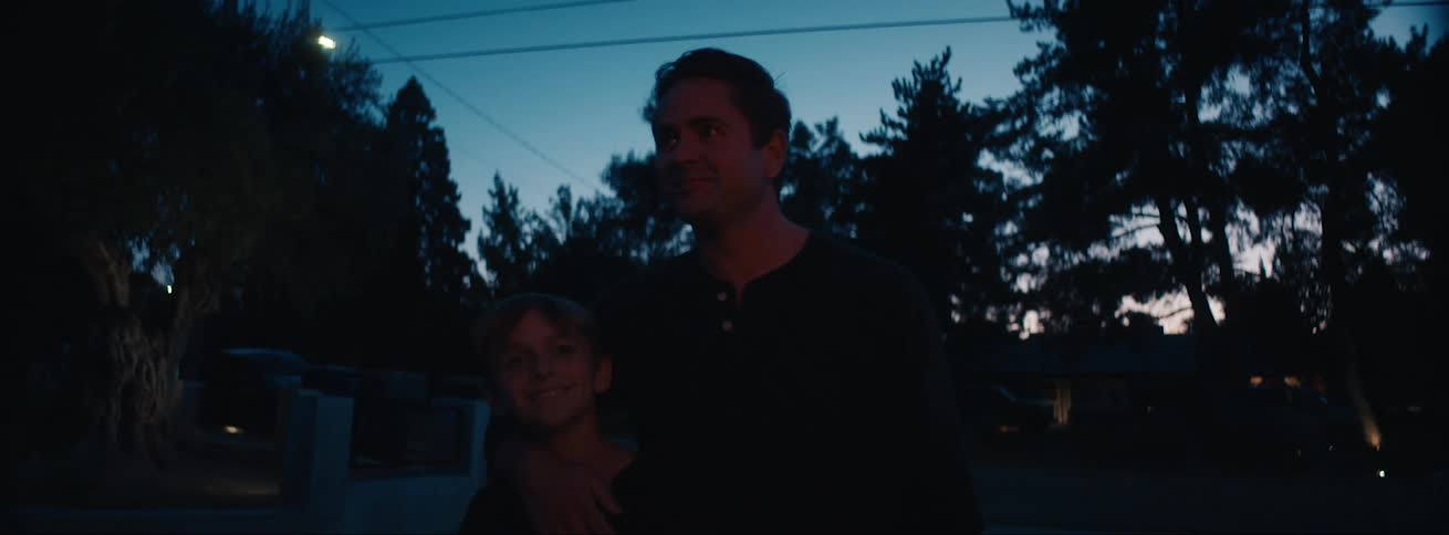 Father and son enjoys fireworks at evening