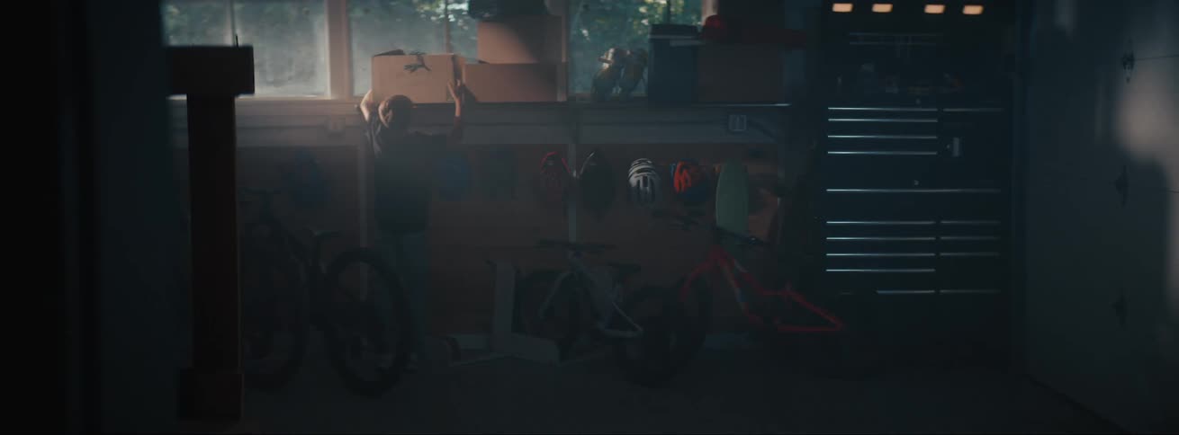 A child carries a box in the basement