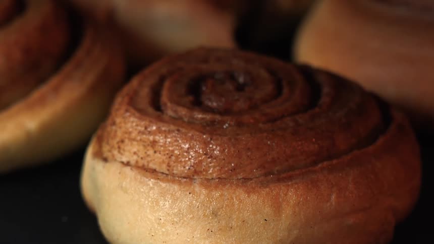 Cinnamon rolls on dark background