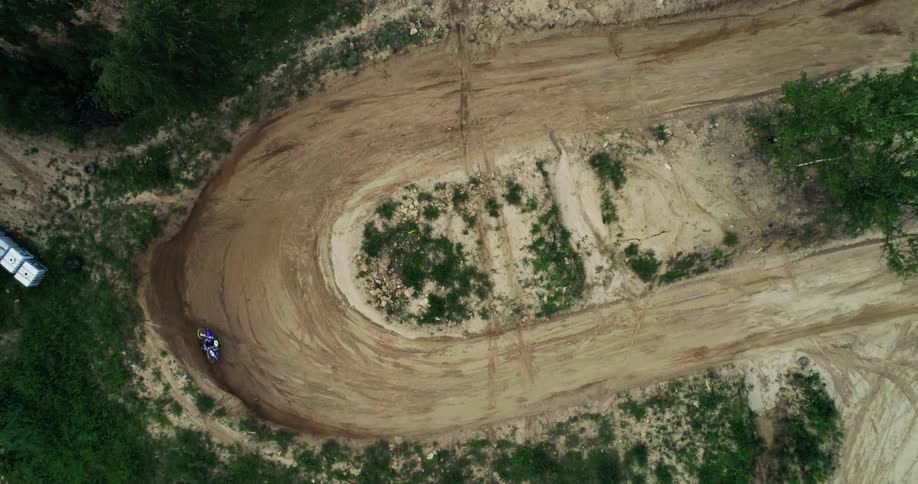 Aerial view of motocross dirt track and rider during the day