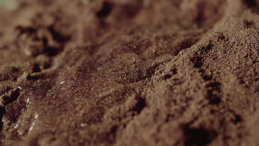 Closeup of water mixing with powder and moving in slow motion