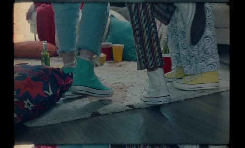 Closeup of the legs of a person walking and meeting friends who jump together
