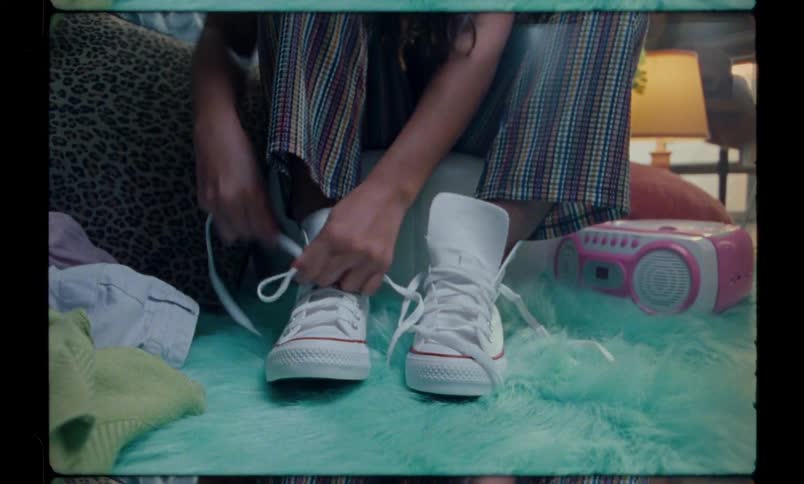 Closeup of a persons shoes while tying their shoelaces