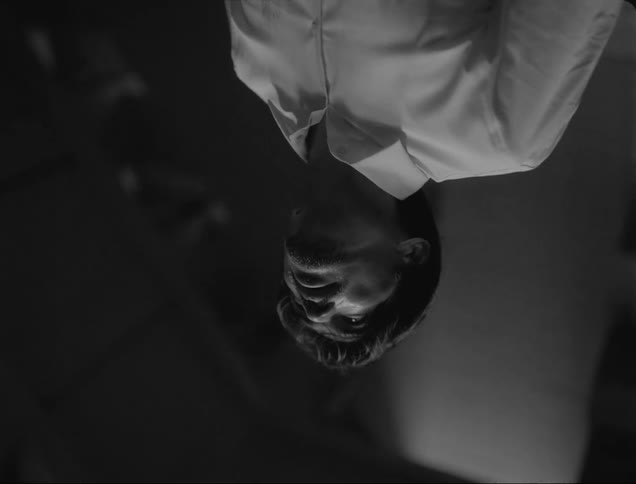 Inverted view of mans head face torso wearing white dress shirt