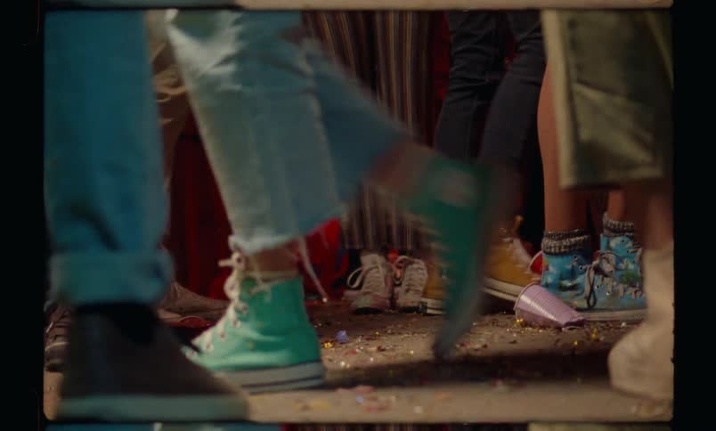 Legs of people walking around in a party at night