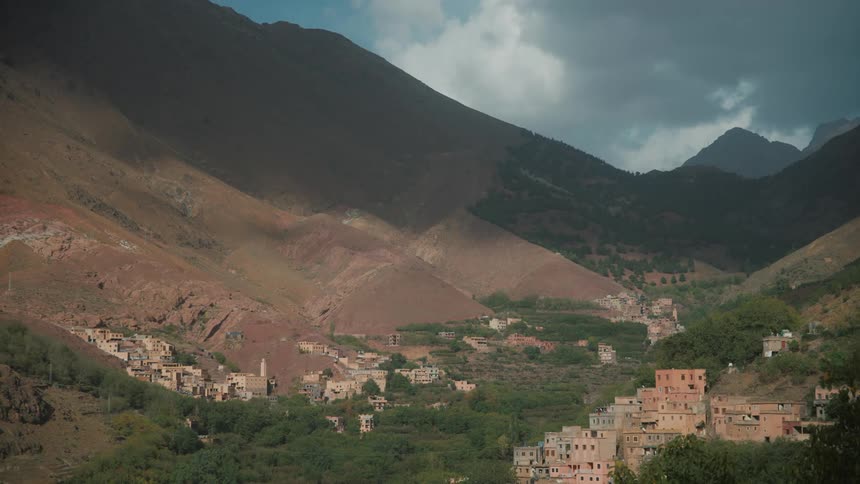 A village in a rural region at the base of mountains and with forests