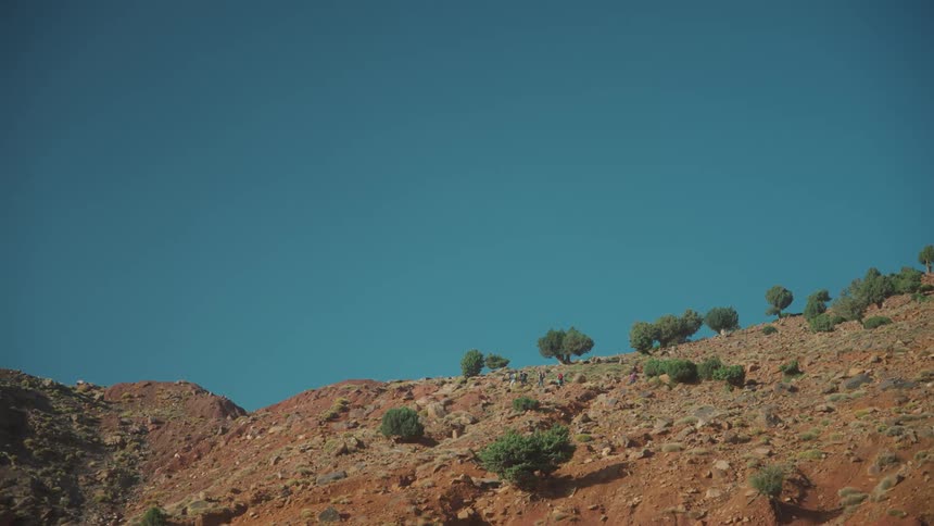 A group of people hiking mountain slope