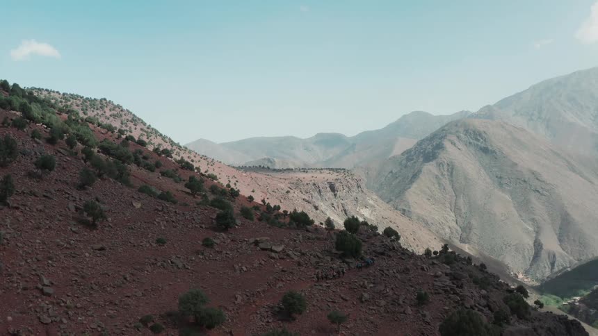 Aerial panorama of people hiking amidst mountains