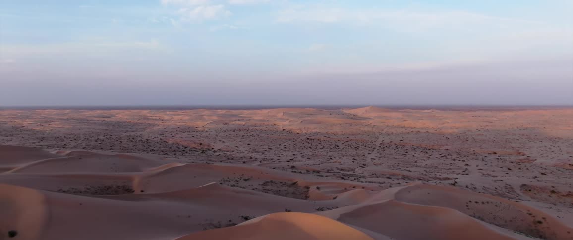 A desert with several sand dunes