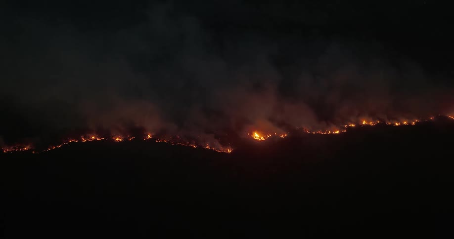 Aerial panorama of a night forest on fire