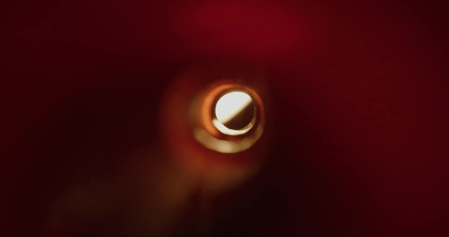 Internal view of a cylinder with external reflections creating shadows