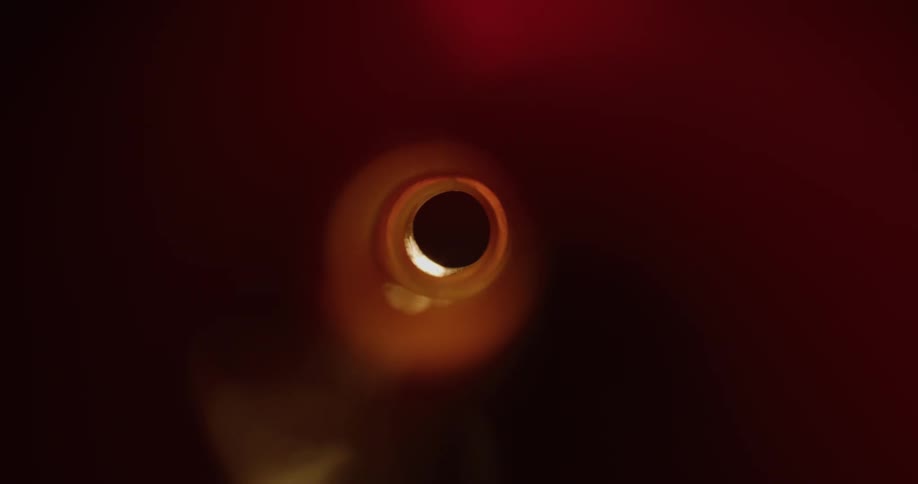 View from inside an abstract bottle with reflections of light passing through the funnel