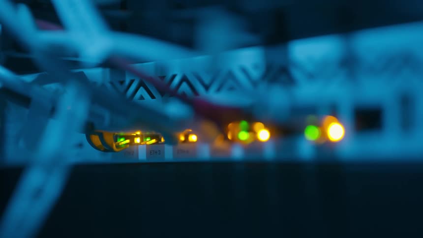 The server rack has blinking lights