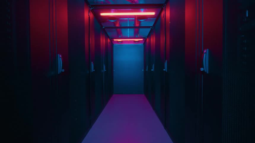 The dark hallway has red lights above
